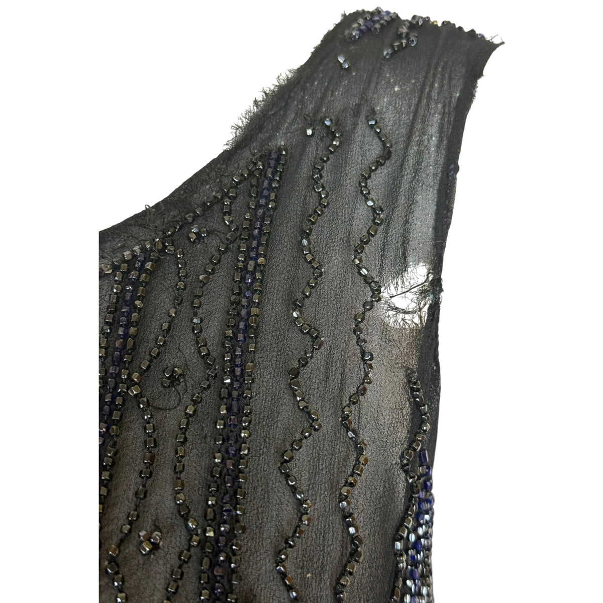 Condition detail showing hole and fraying at left shoulder of antique 1920s beaded silk chiffon dress
