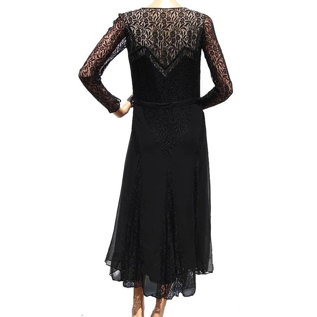 vintage 1930s black long-sleeve midi dress with an intricate lace pattern on the bodice and sleeves, featuring a matching waist tie and sheer tulle skirt, shown from the back