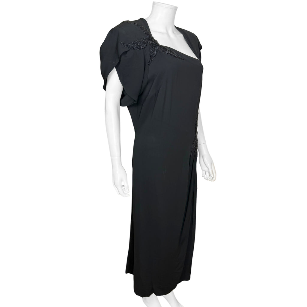 right side view of 1940s black crepe couture gown with asymmetrical neckline