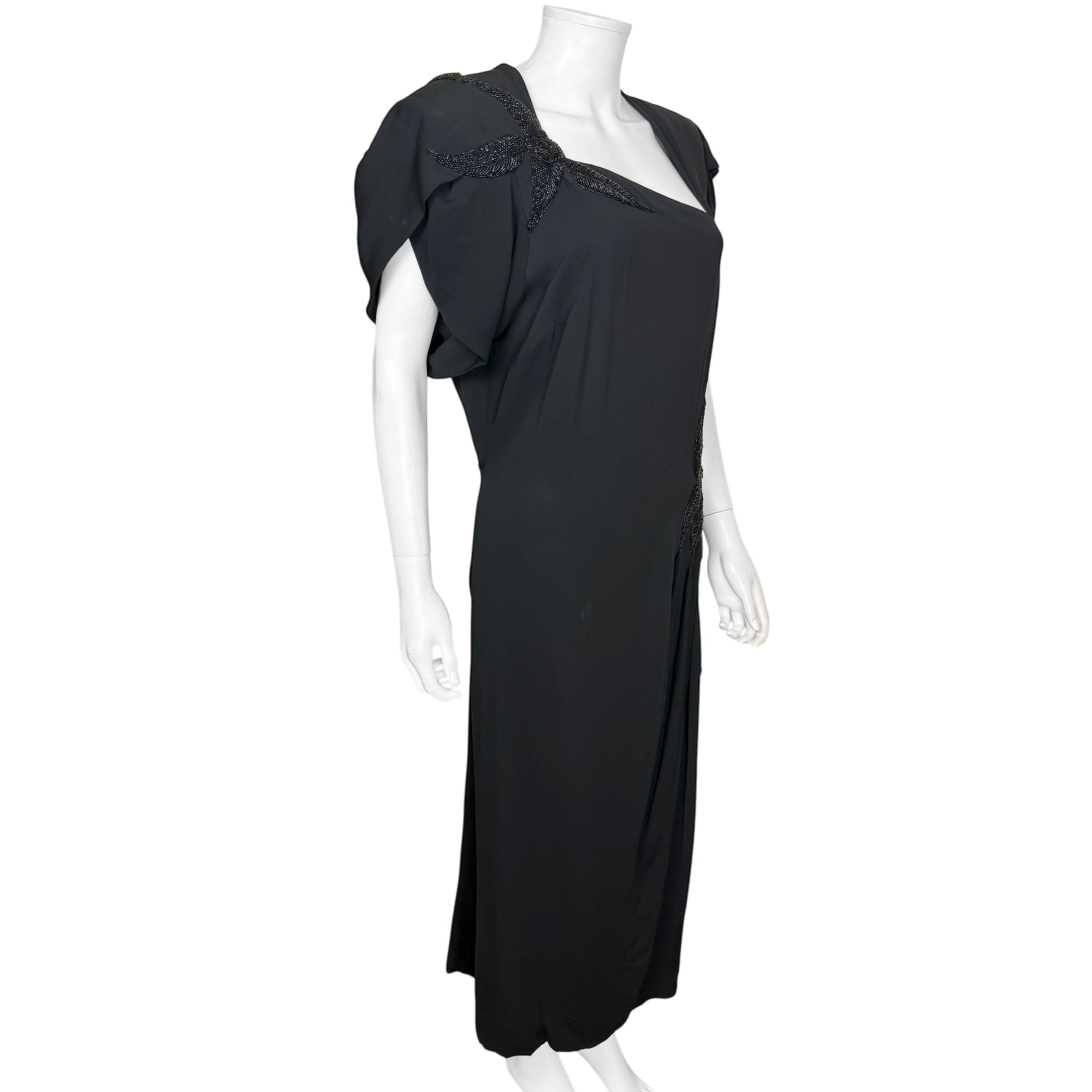 right side view of 1940s black crepe couture gown with asymmetrical neckline