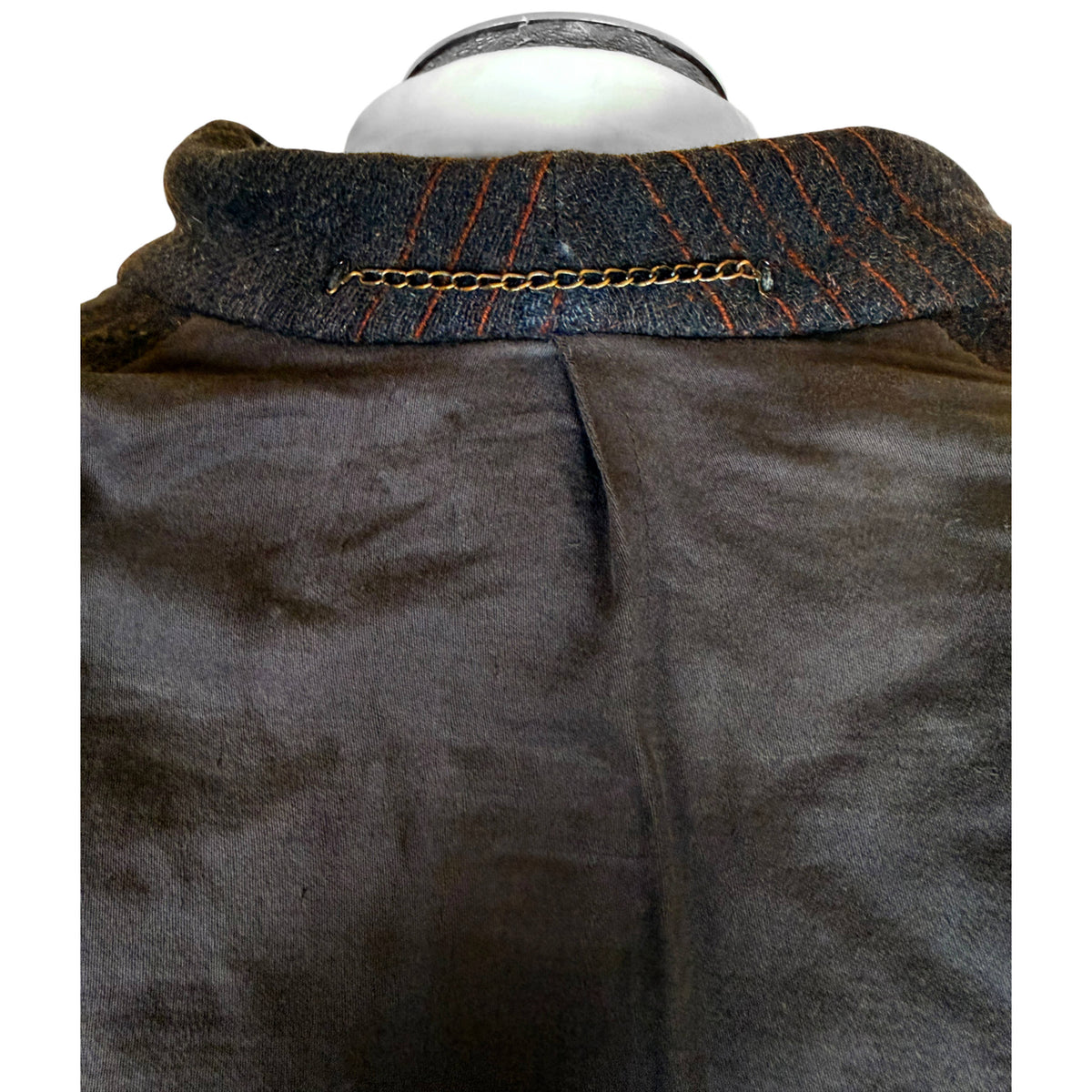 Close-up of interior collar and metal chain hanging loop on vintage 1930s men's wool overcoat