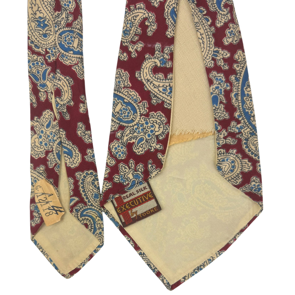 Back of vintage Tooke silk tie with original dry-cleaning ticket