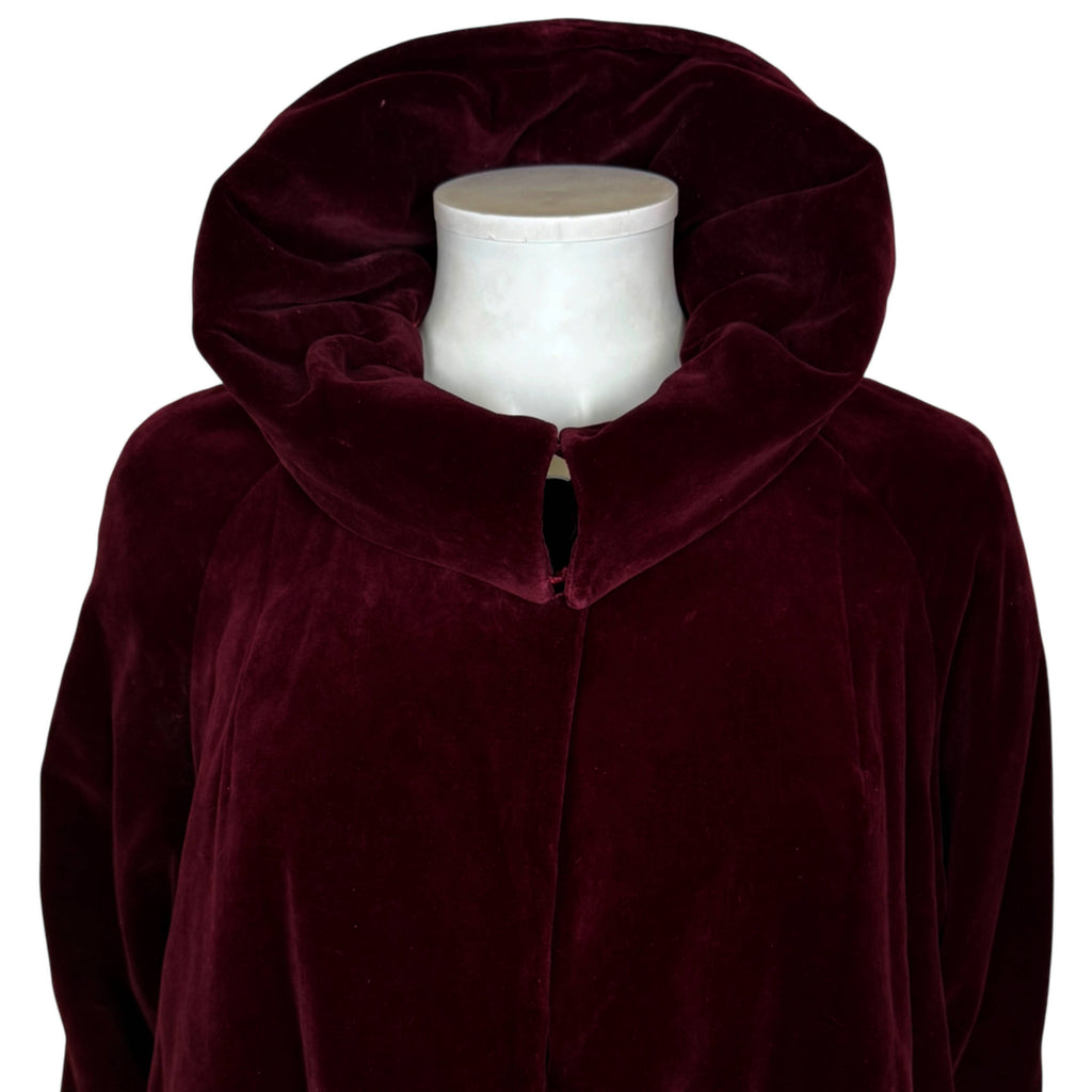 Close-up of vintage burgundy velvet opera coat with large collar arranged in raised position