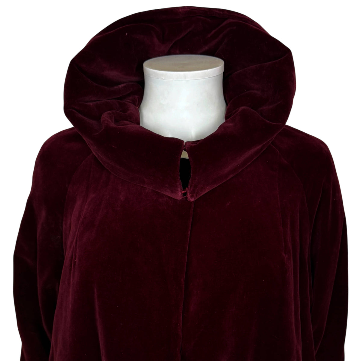 Close-up of vintage burgundy velvet opera coat with large collar arranged in raised position