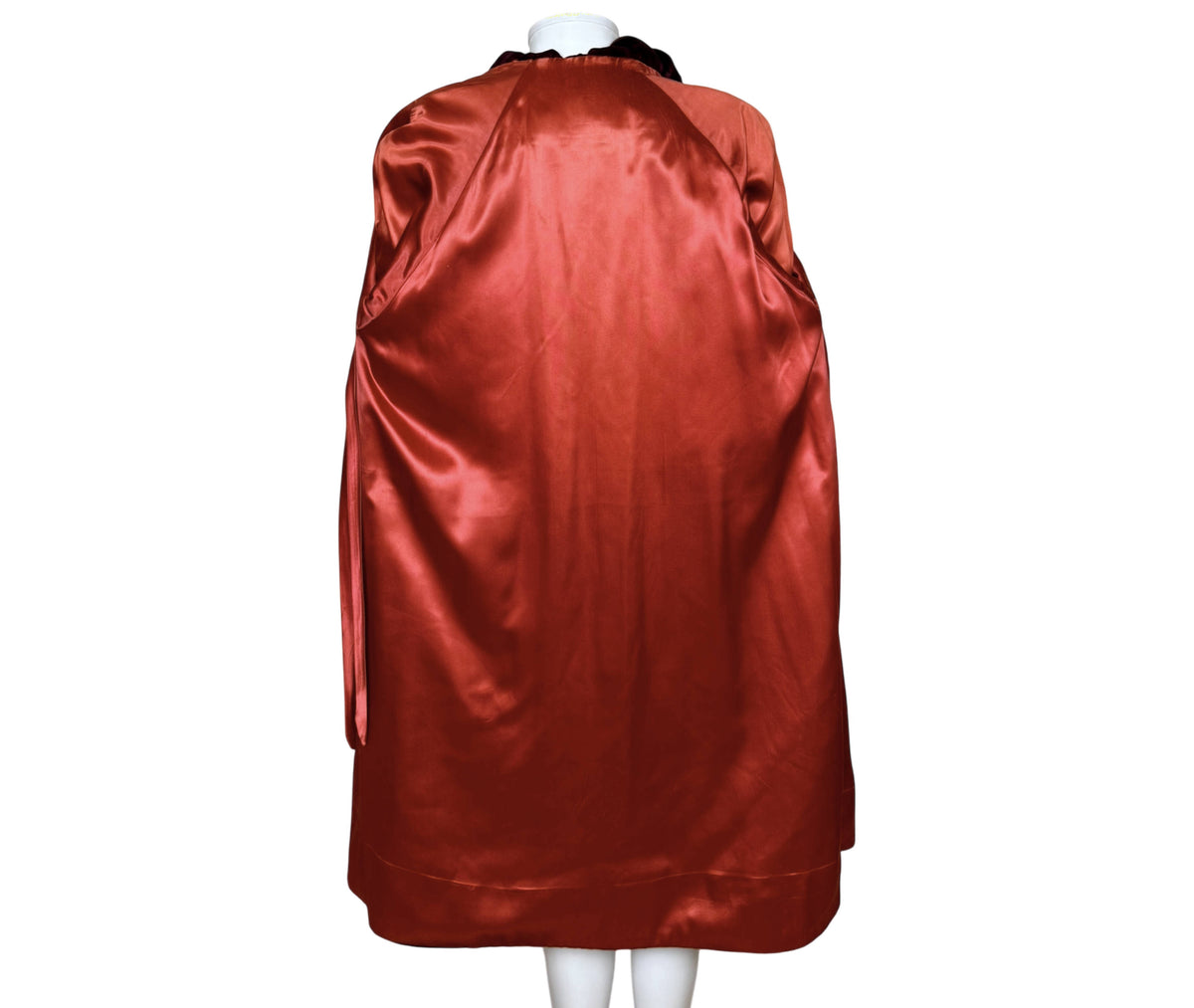 Interior of vintage 1950s burgundy velvet evening coat showing contrasting rust-red satin lining