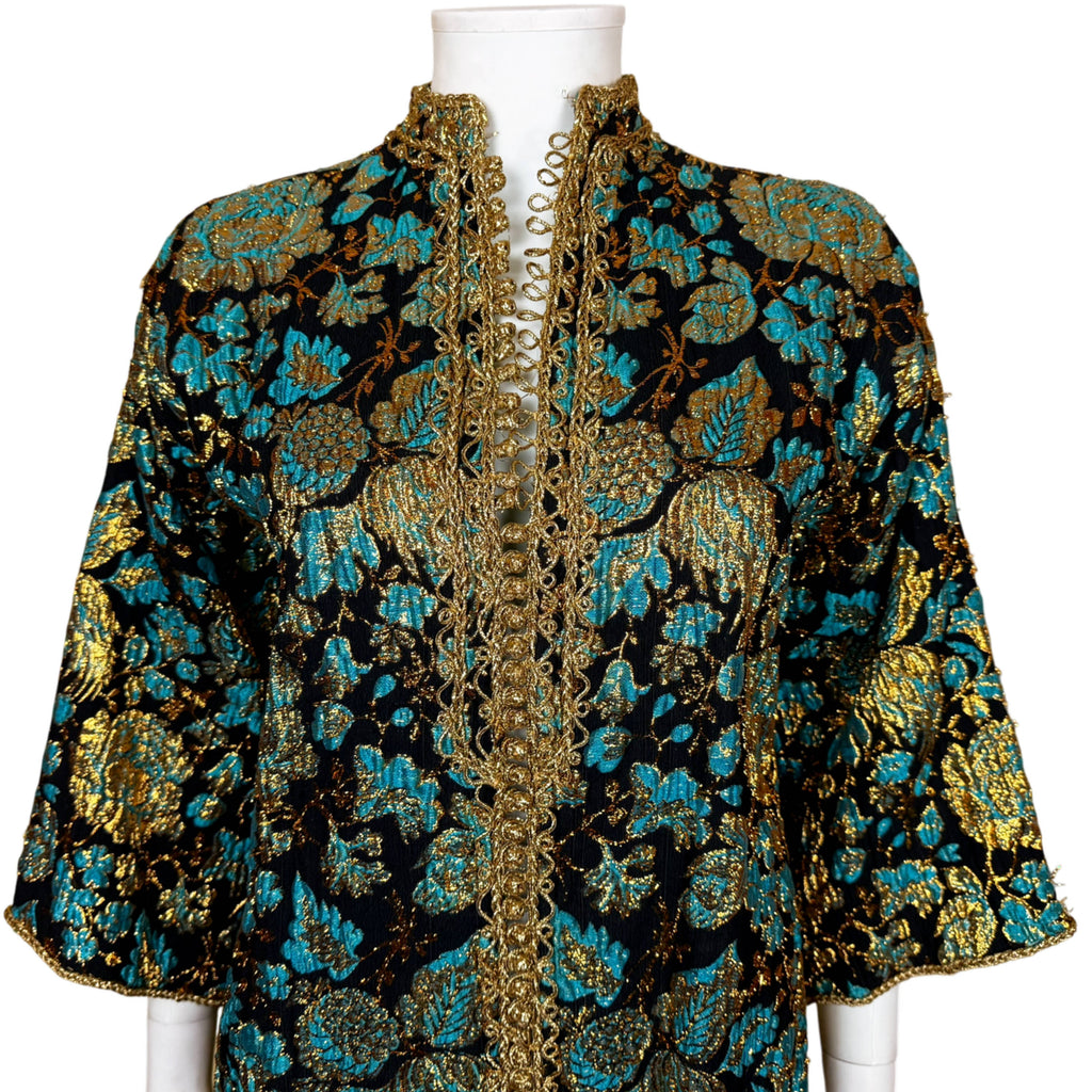 Close-up of Moroccan kaftan upper bodice showing floral brocade, gold sfifa braid and standing collar