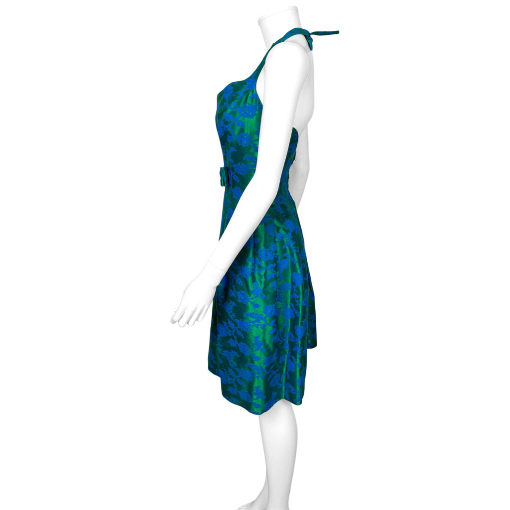 Side profile of vintage Rappi halter cocktail dress showing fitted bodice and pleated floral brocade skirt