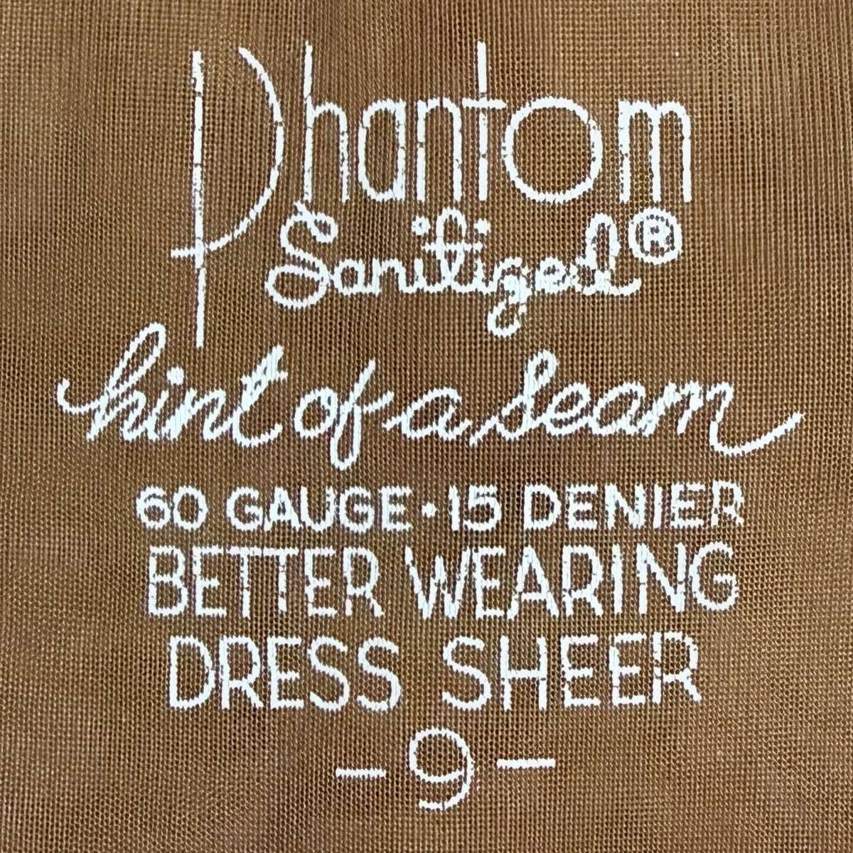 Close-up of a brown nylon stocking stamping 'Phantom Sanitized hint of a seam 60 GAUGE -15 DENIER BETTER WEARING DRESS SHEER -9-'.