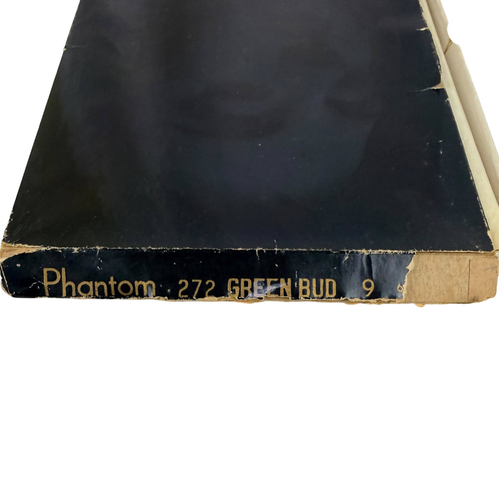 A close-up of a vintage stocking  box, showing a dark black cover with gold printed text reading 'Phantom 272 GREEN BUD 9' on the spine edge