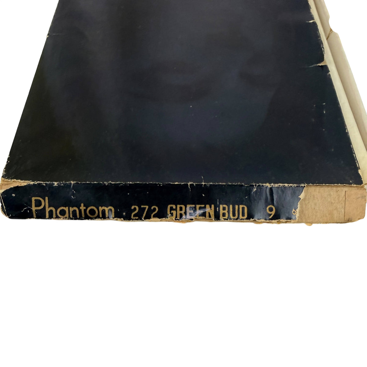 A close-up of a vintage stocking  box, showing a dark black cover with gold printed text reading 'Phantom 272 GREEN BUD 9' on the spine edge