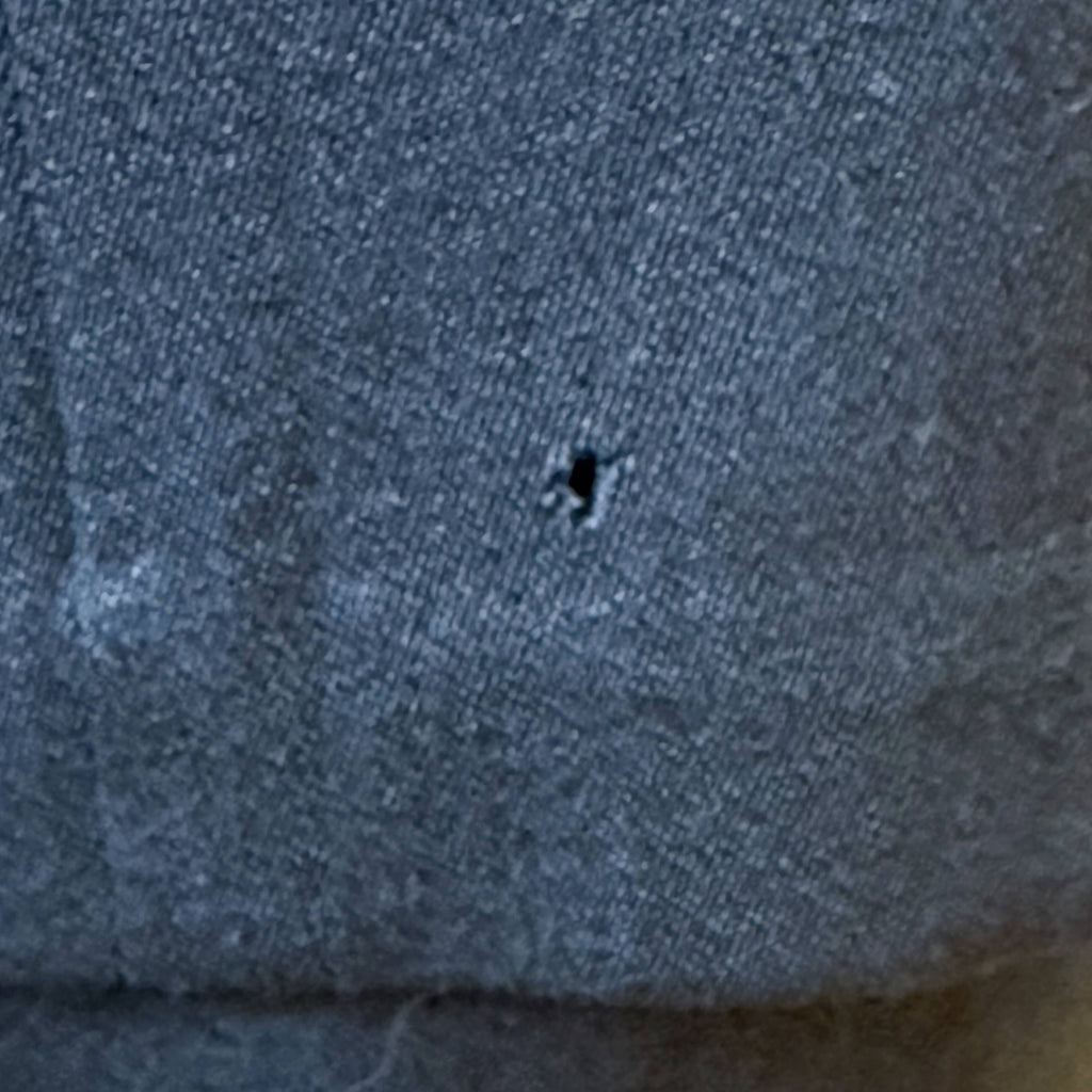 small flaw hole in vintage suit fabric close up