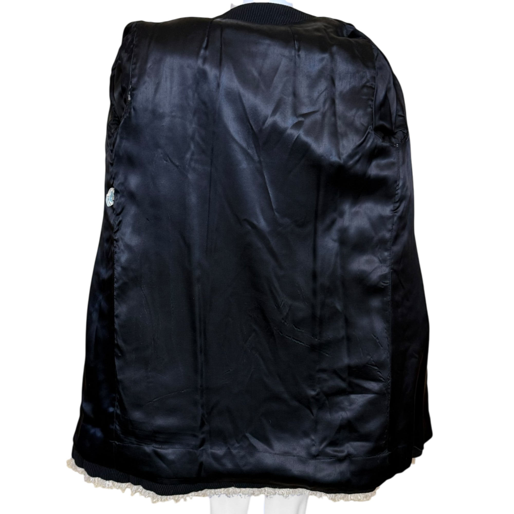 Lining of 1960s black wool coat mouton trim front