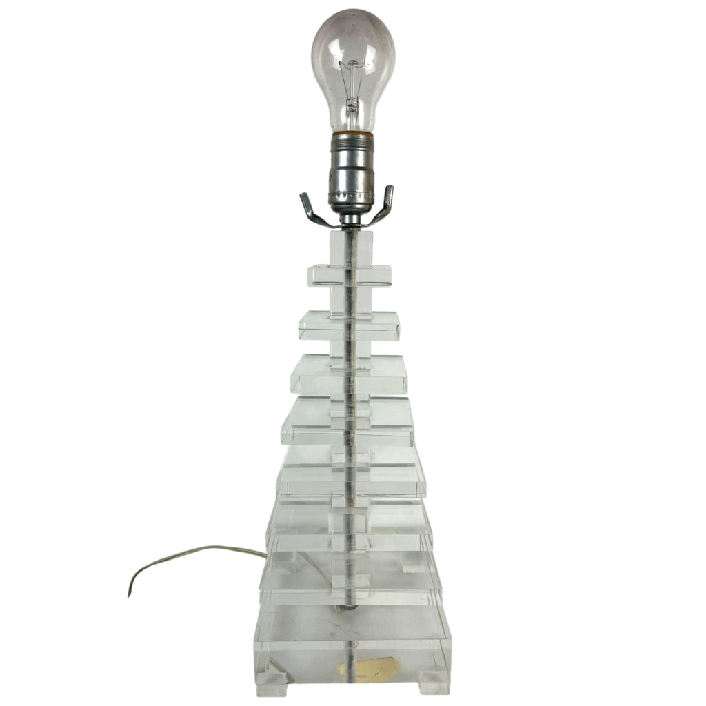 A vintage table lamp featuring a clear lucite or acrylic tiered pyramid base 