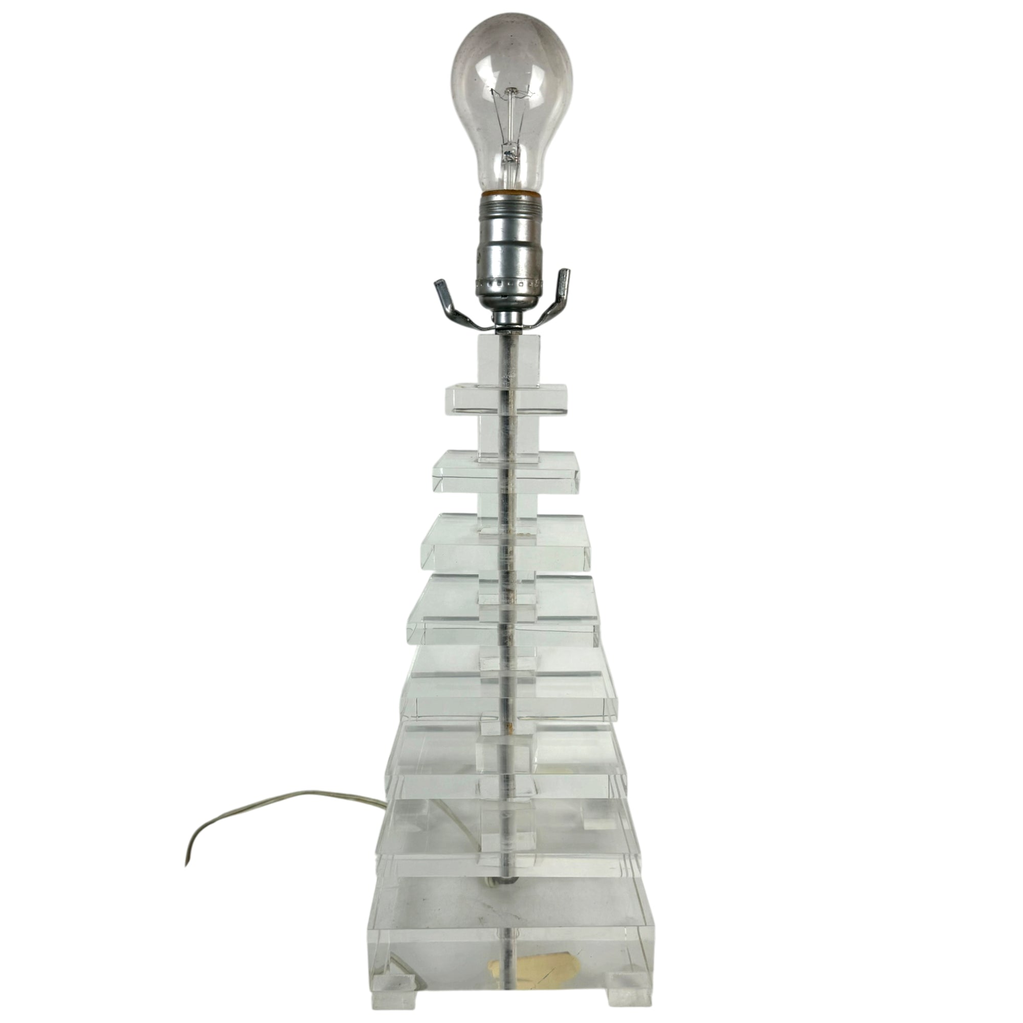 A vintage table lamp featuring a clear lucite or acrylic tiered pyramid base 