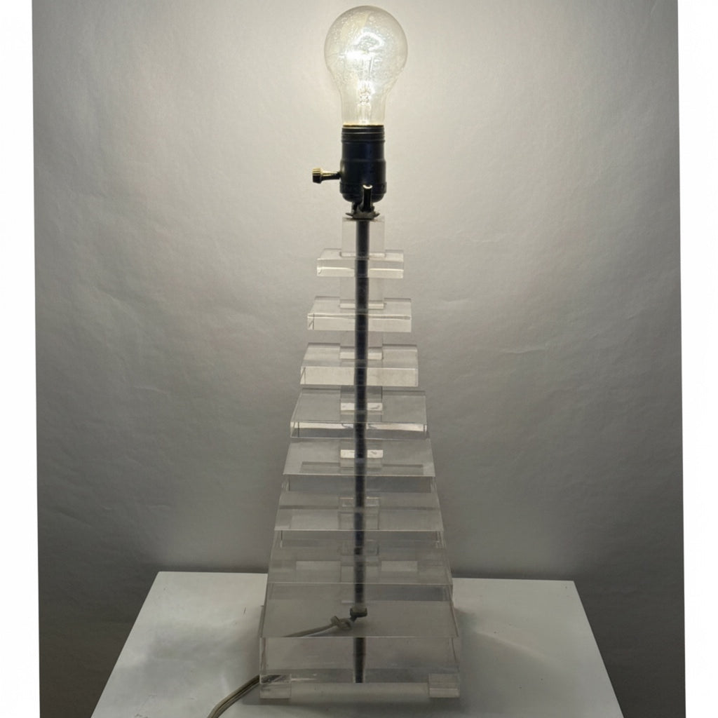 A lit stacked lucite table lamp 