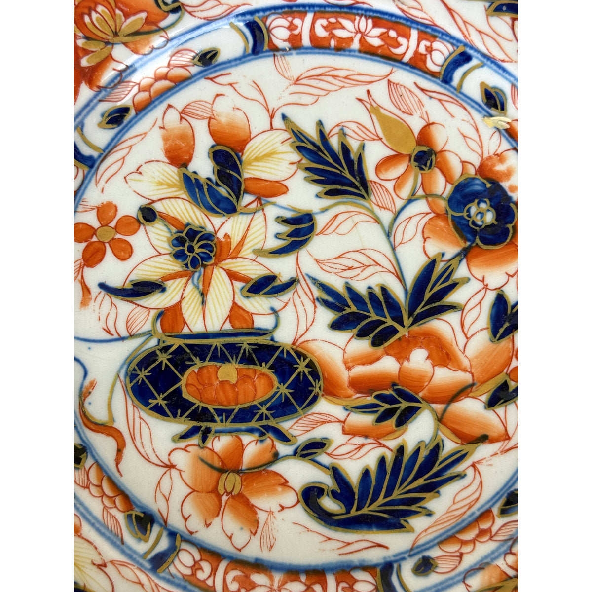 Close-up of hand painted cobalt blue iron red and gilt Imari floral decoration