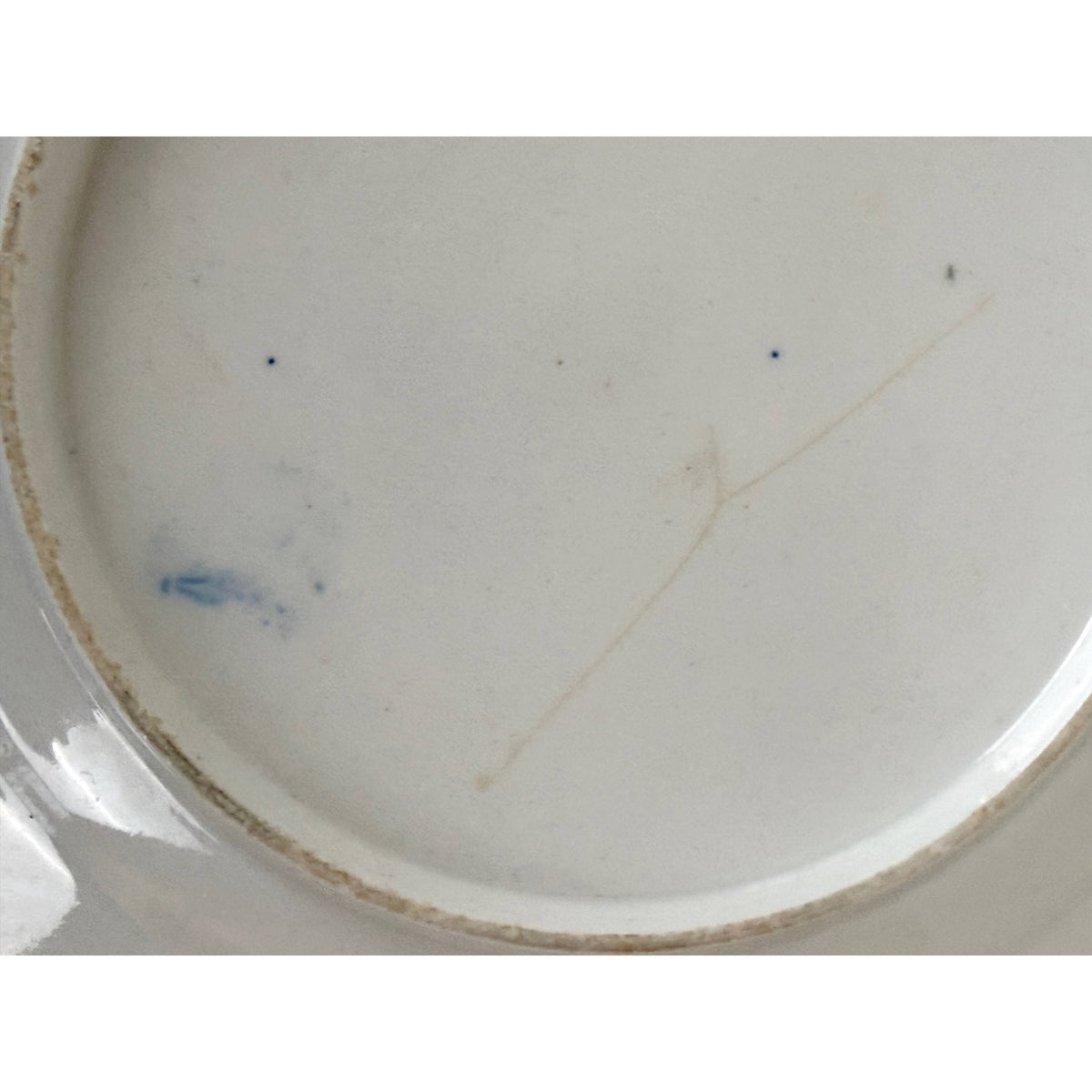 Close-up of underside showing impact hairline and blue workman's mark