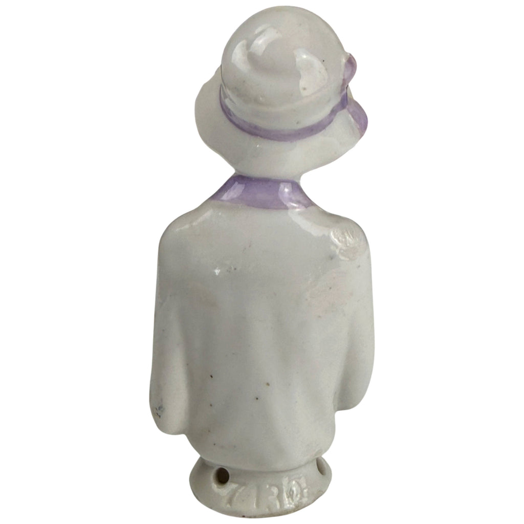 Back view of antique German porcelain half-doll showing cloche hat, lavender collar and impressed model number 7130
