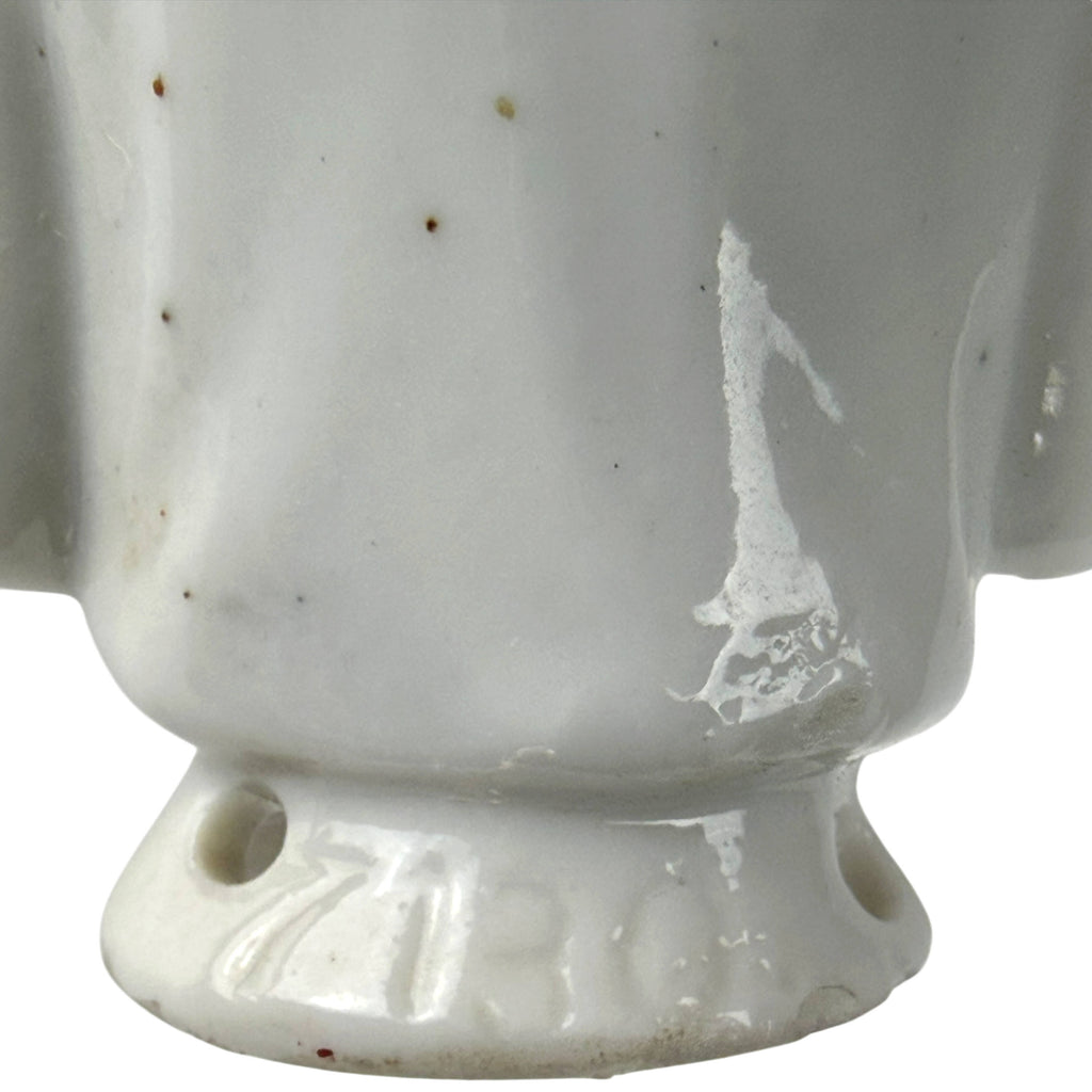 Close-up of impressed model number 7130 on the back of the antique porcelain half-doll base