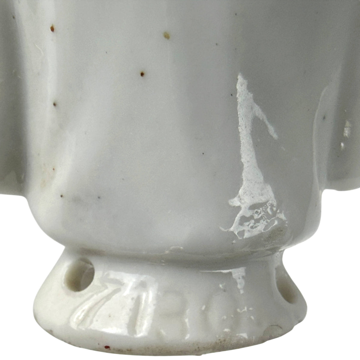 Close-up of impressed model number 7130 on the back of the antique porcelain half-doll base