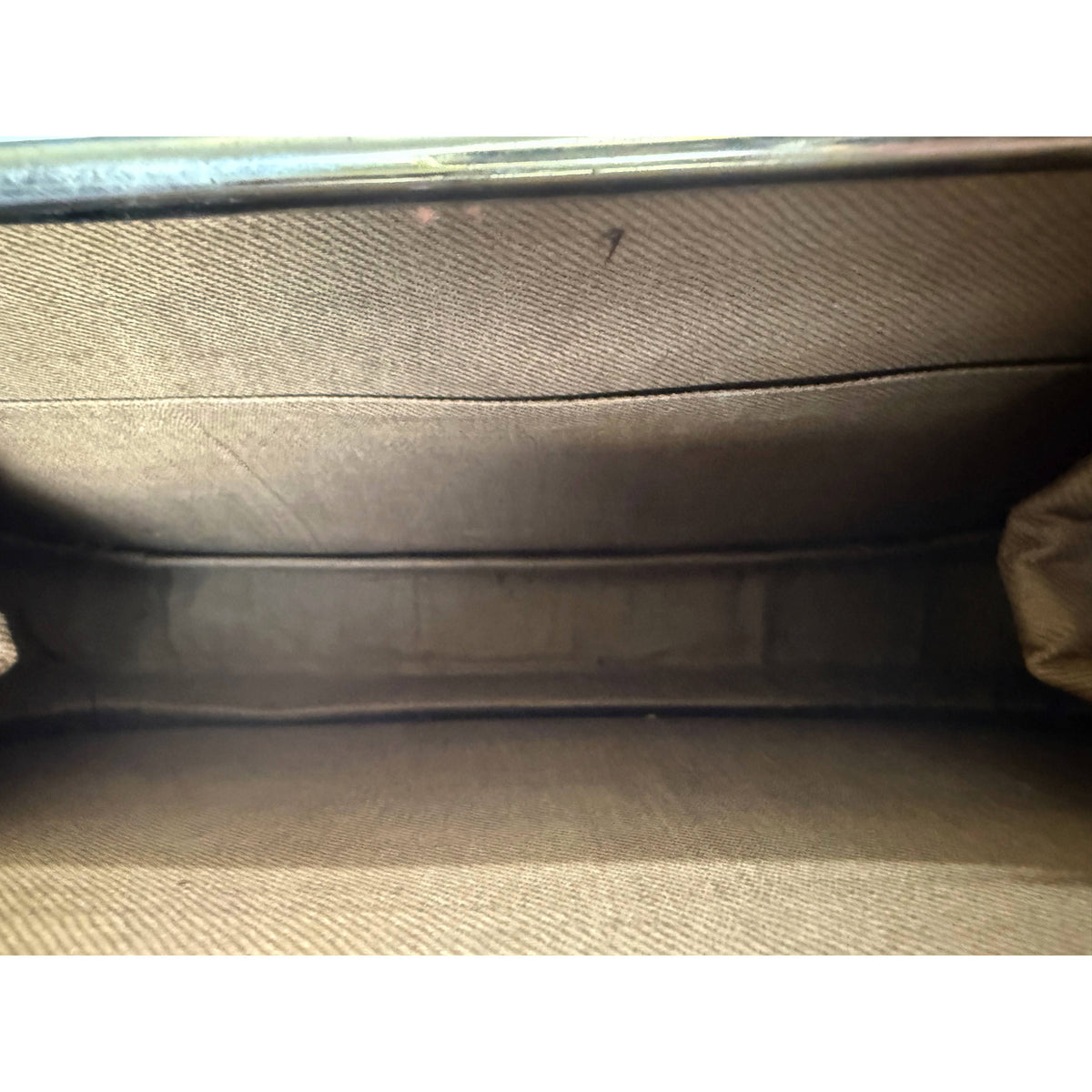 Interior detail of Edwardian handbag showing clean tan fabric lining and structured compartment