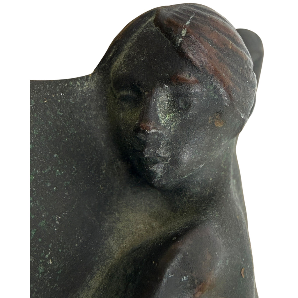 Close-up of  bronze nude woman’s face 