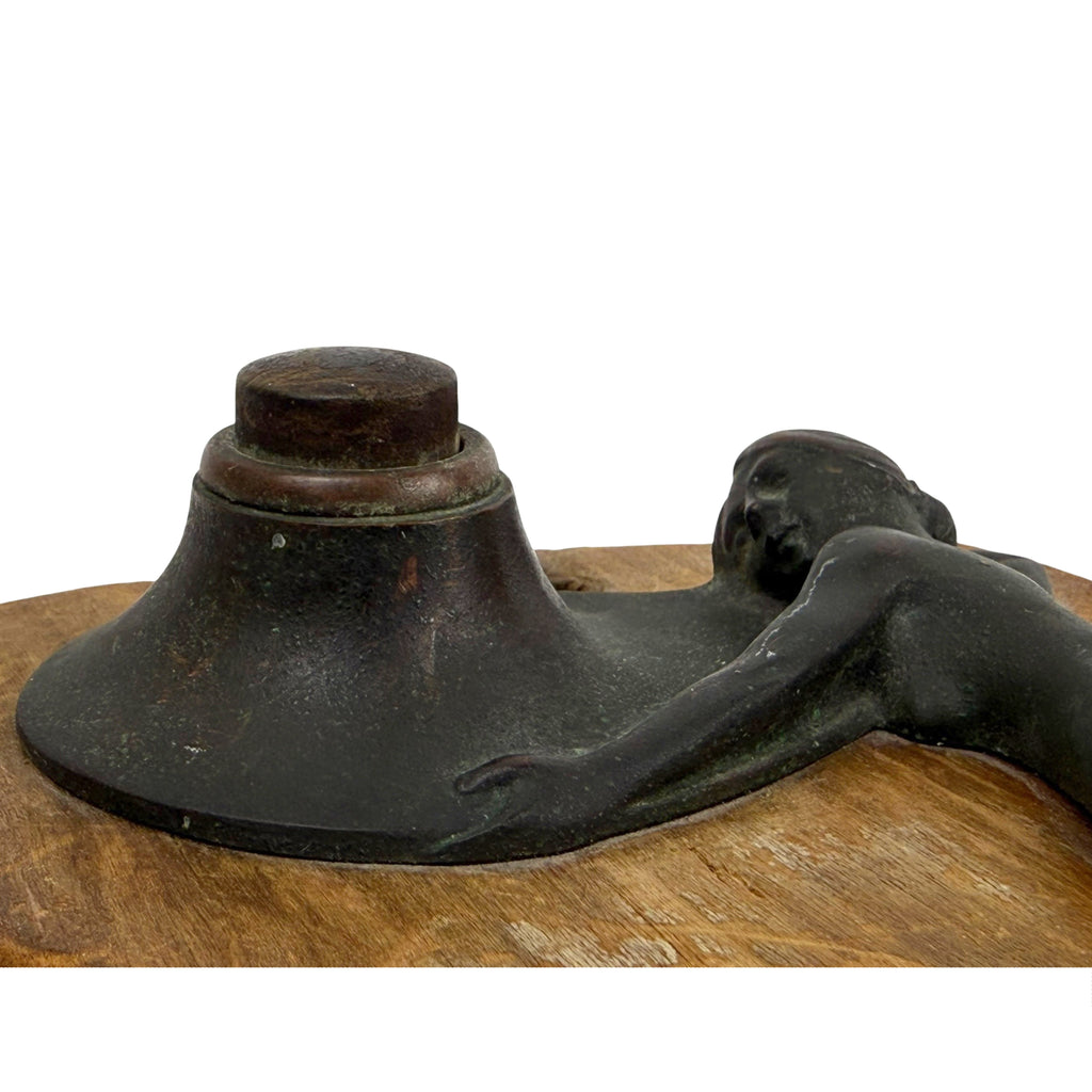 Patinated bronze bell push with green verdigris and reddish highlights