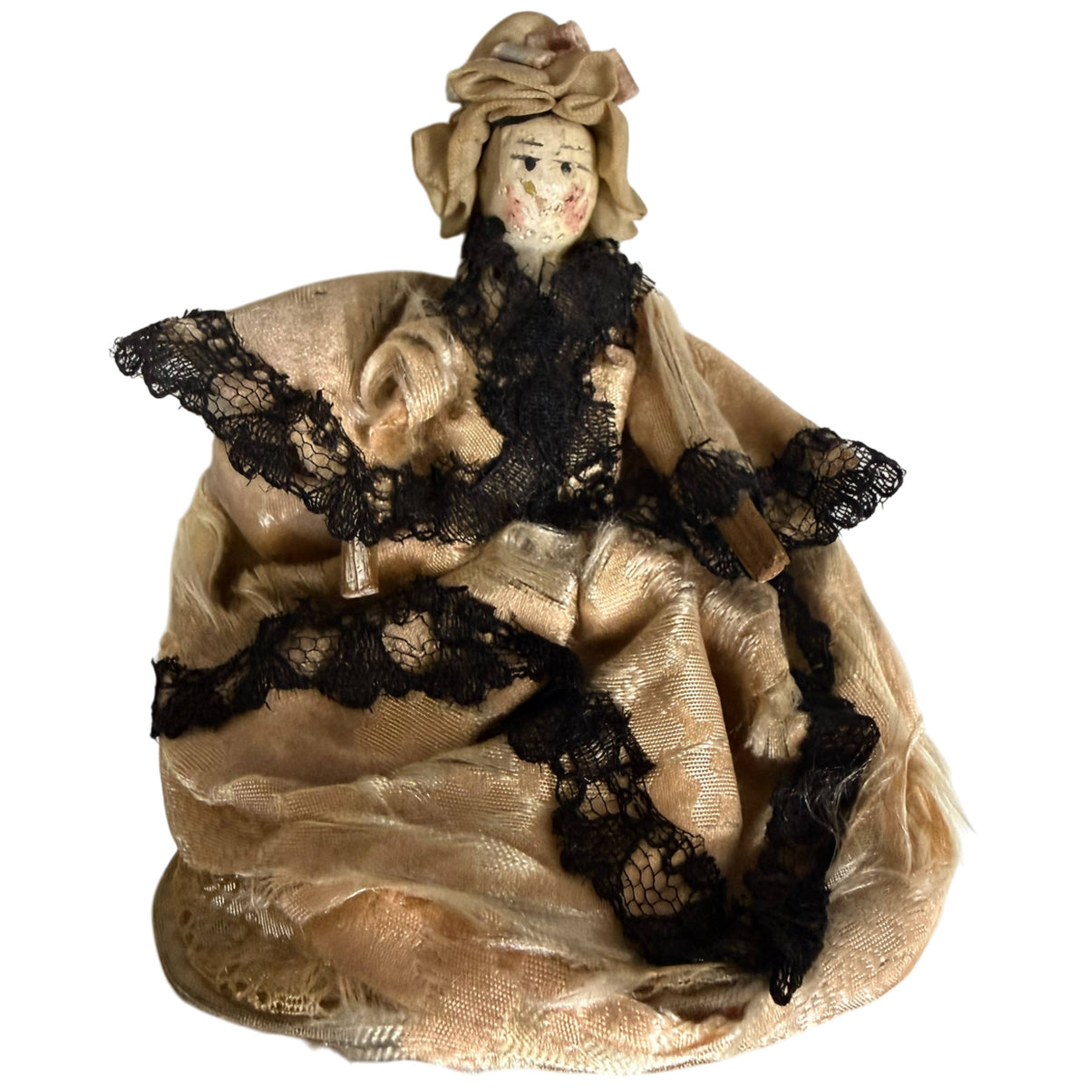 Antique German Grödnertal wooden peg doll in original cream silk ball gown with black lace and matching bonnet, front view
