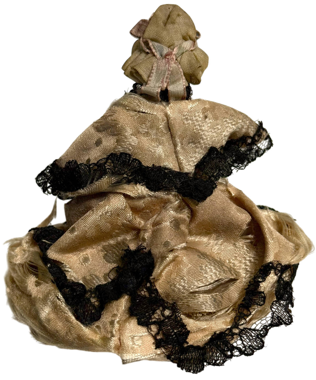 Back view of antique Grödnertal peg doll showing original patterned silk ball gown, black lace trimming and bonnet ribbons