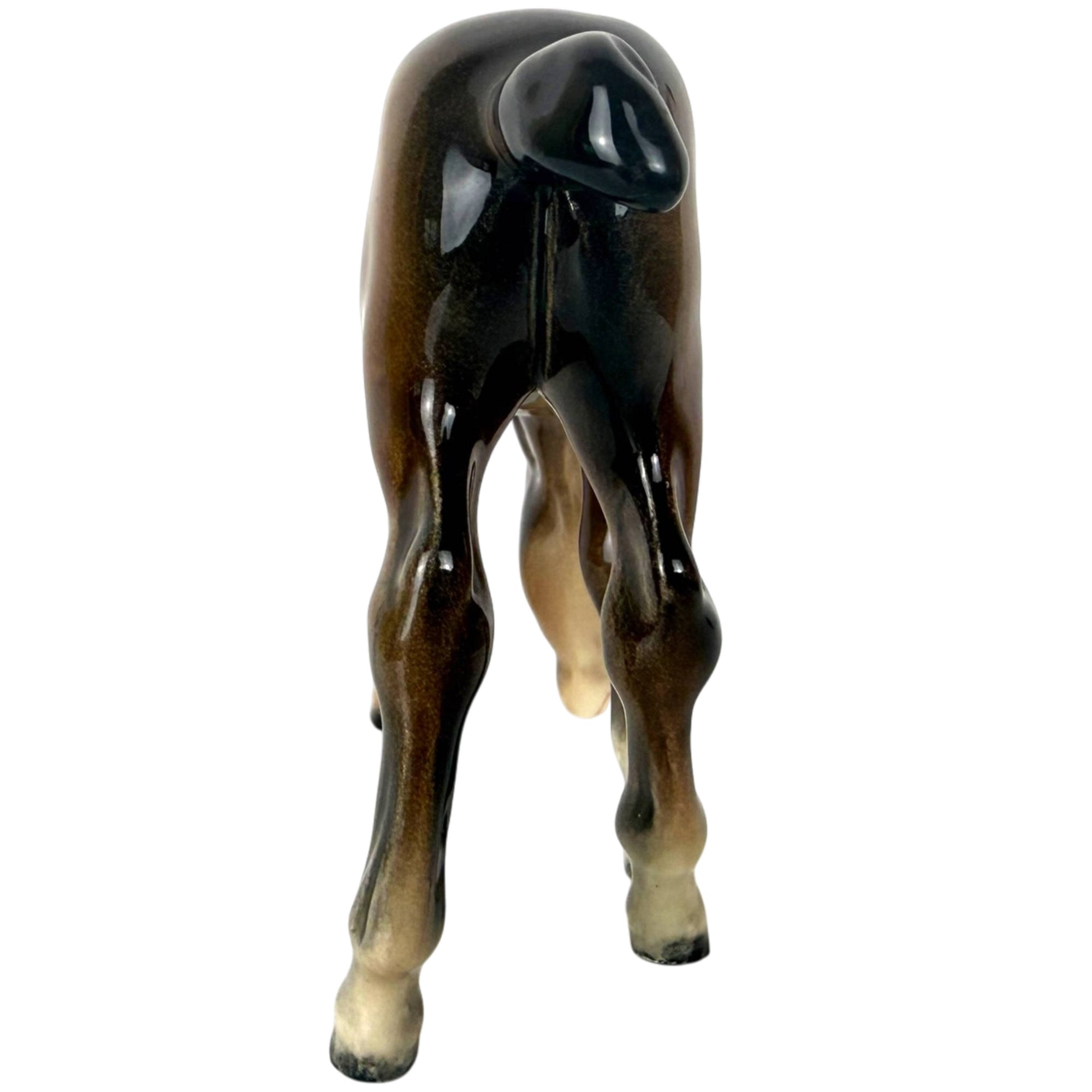 back view of 946 grazing foal by beswick