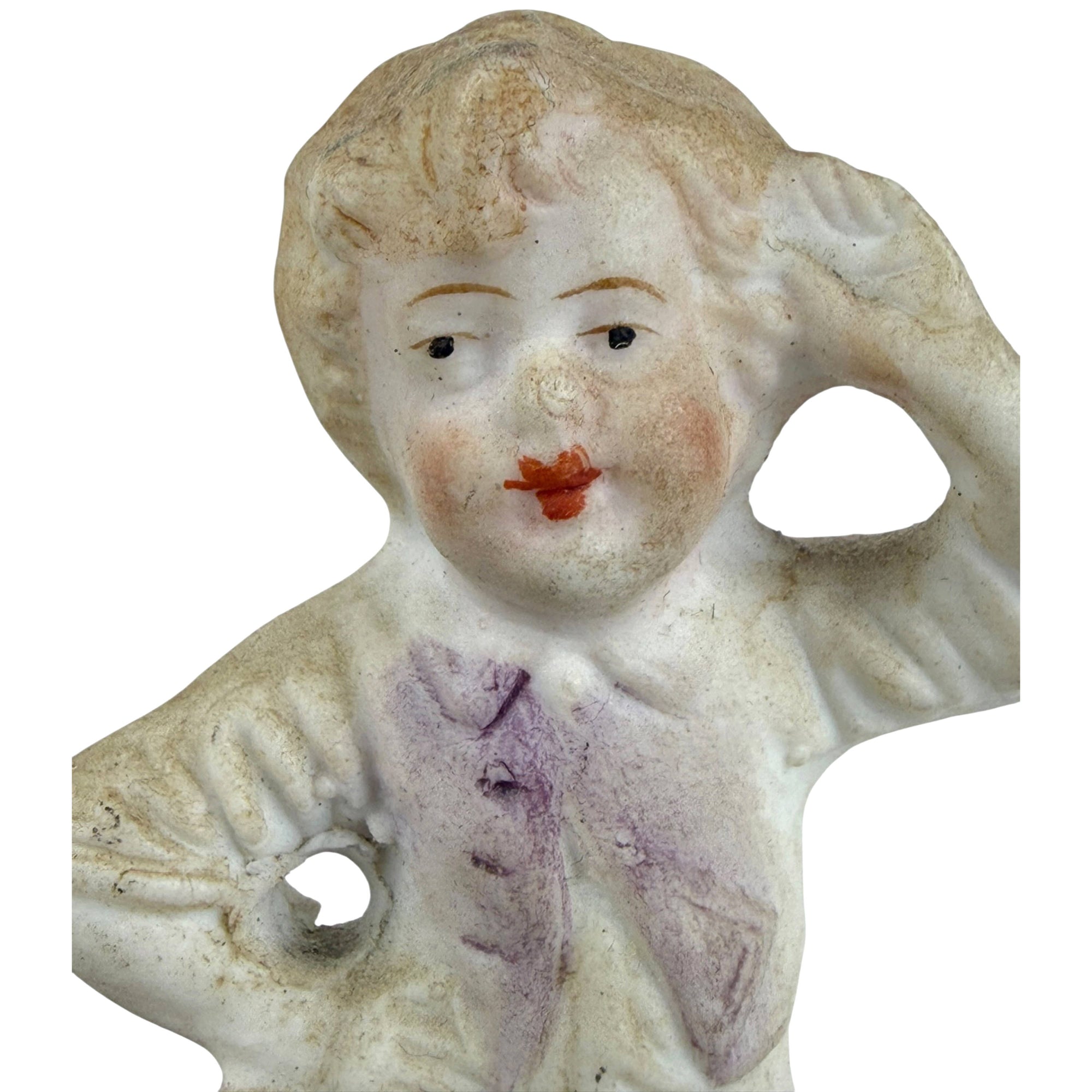close up of boy listening to shell antique figurine