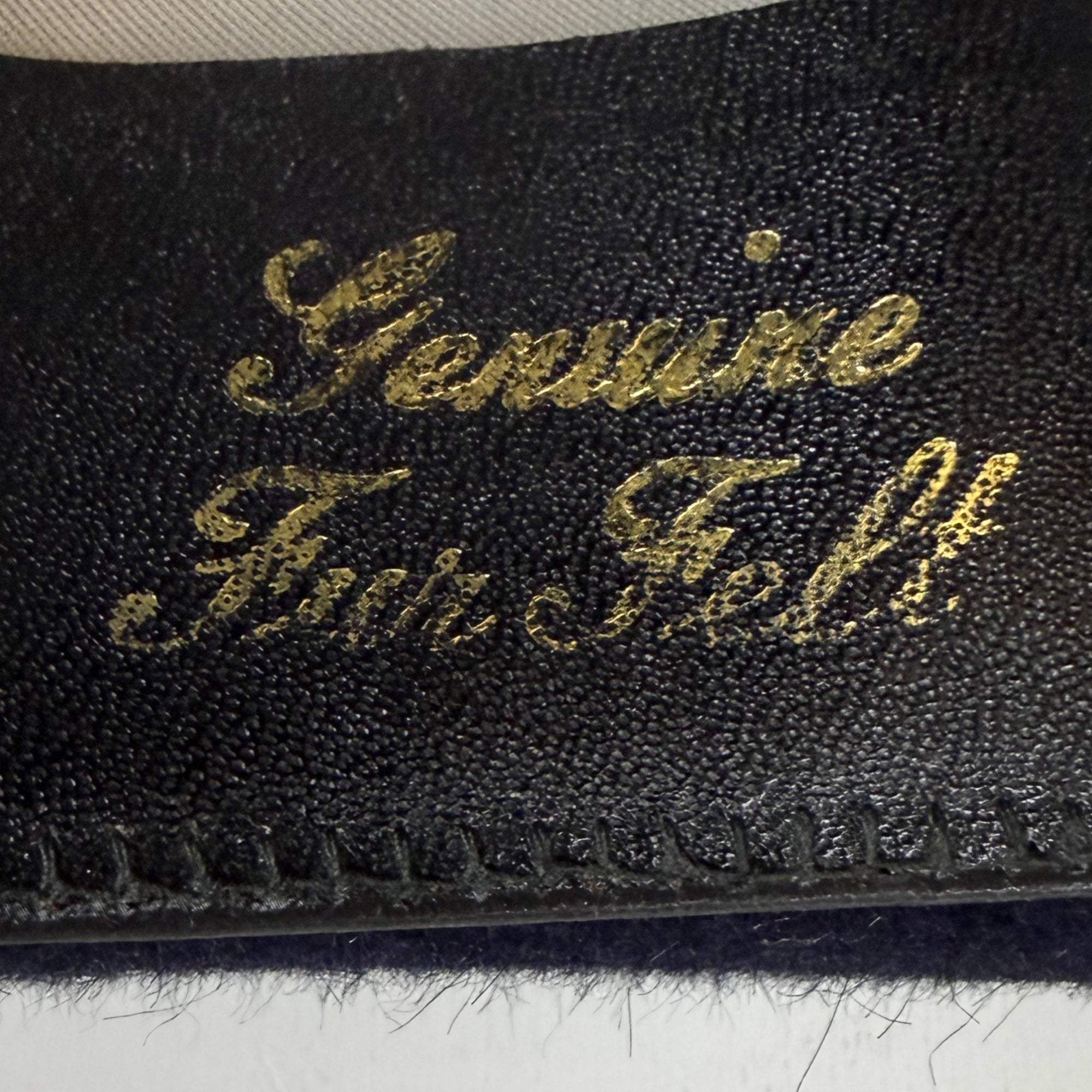 Close-up of Genuine Fur Felt stamp on leather sweatband of 1960s navy fedora
