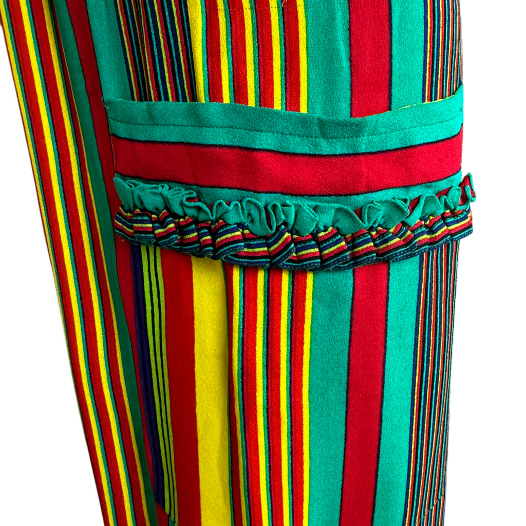 Detail of decorative patch pocket with green and red trim and double ruffle on Céline striped dress