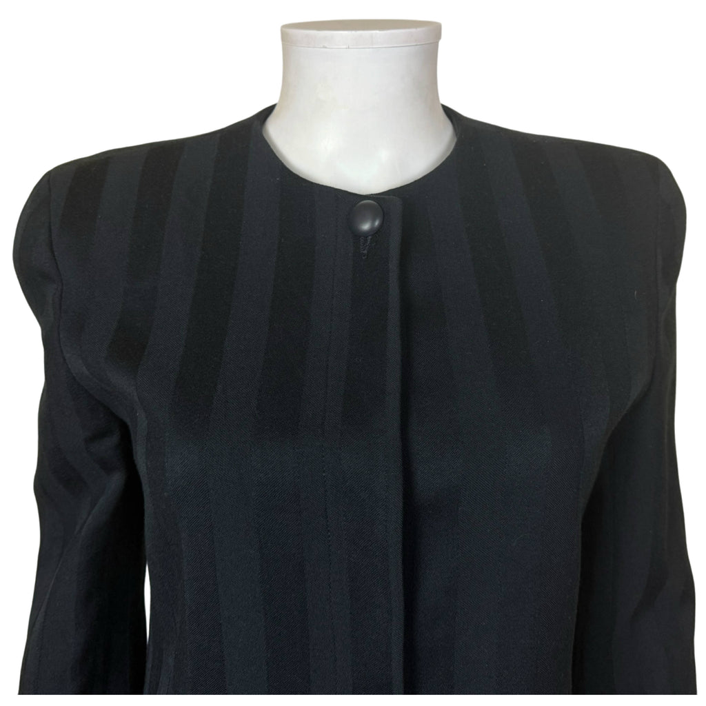 Close-up of Christian Dior collarless blazer showing rounded neckline, covered front placket and single black button