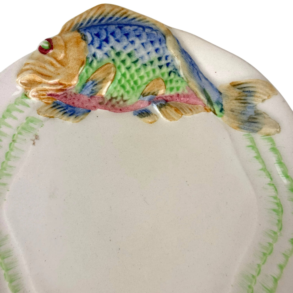 Close up of carp fish on clarice cliff under plate