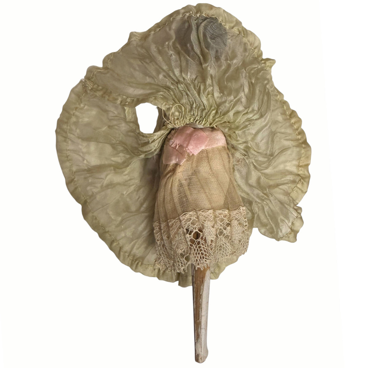 Underside of antique Grödnertal doll silk skirt showing gathered waistband, layered undergarments and lace-trimmed underskirt