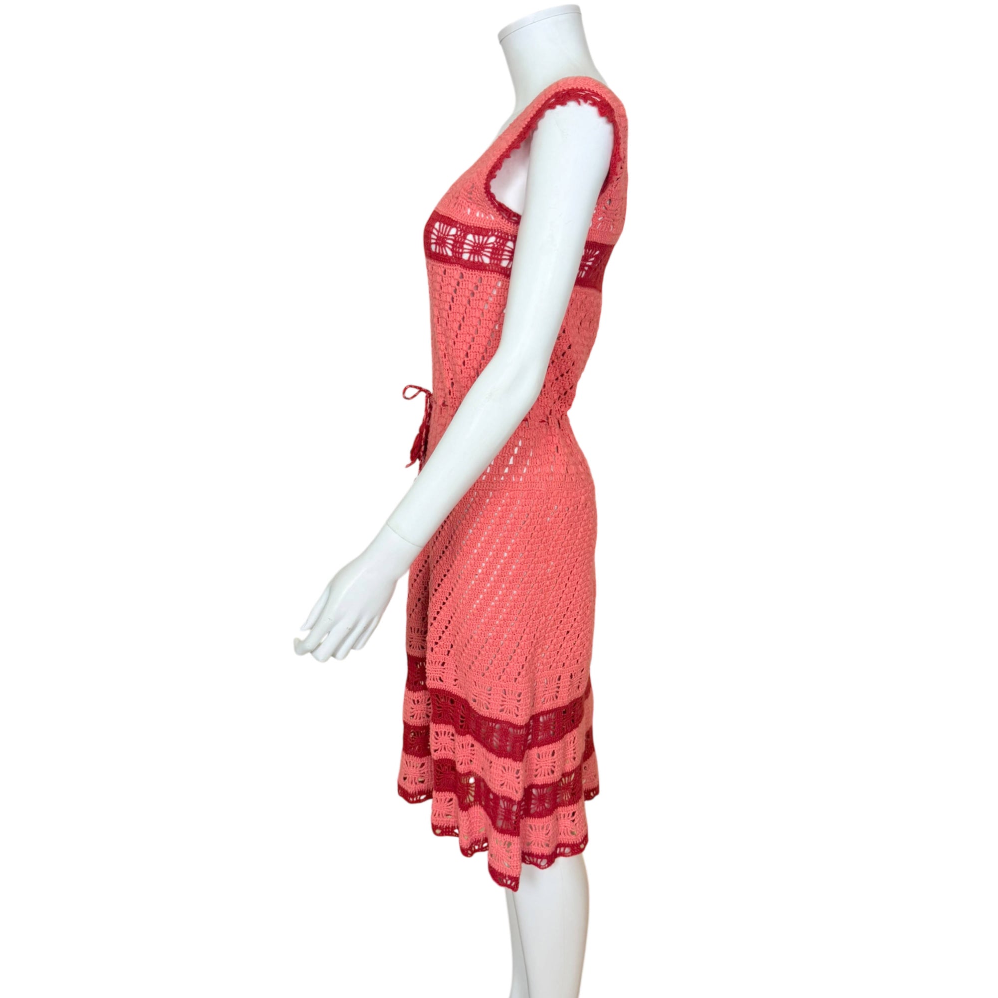 Vintage coral crochet dress displayed on mannequin, left side view