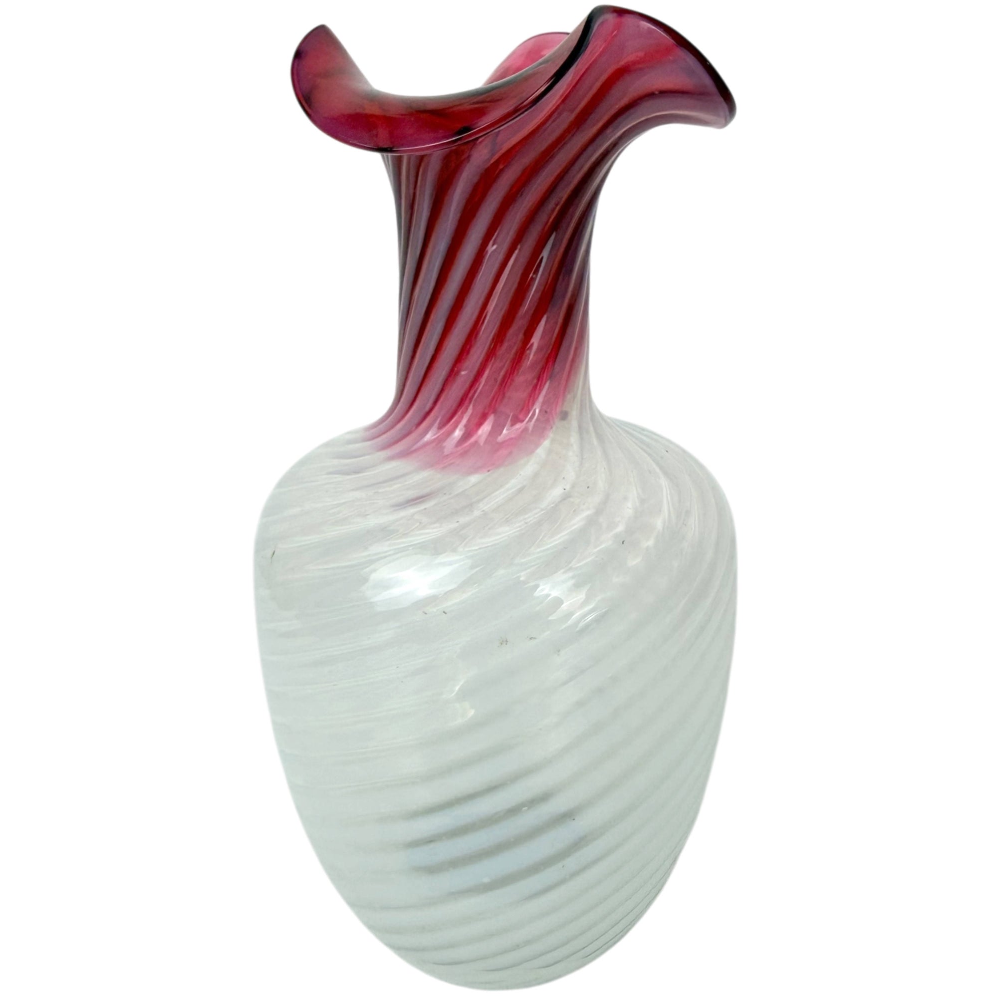 A decorative glass vase with a ribbed white bulbous body and a flared neck featuring vertical dark red and pink swirls, shown against a plain white background.