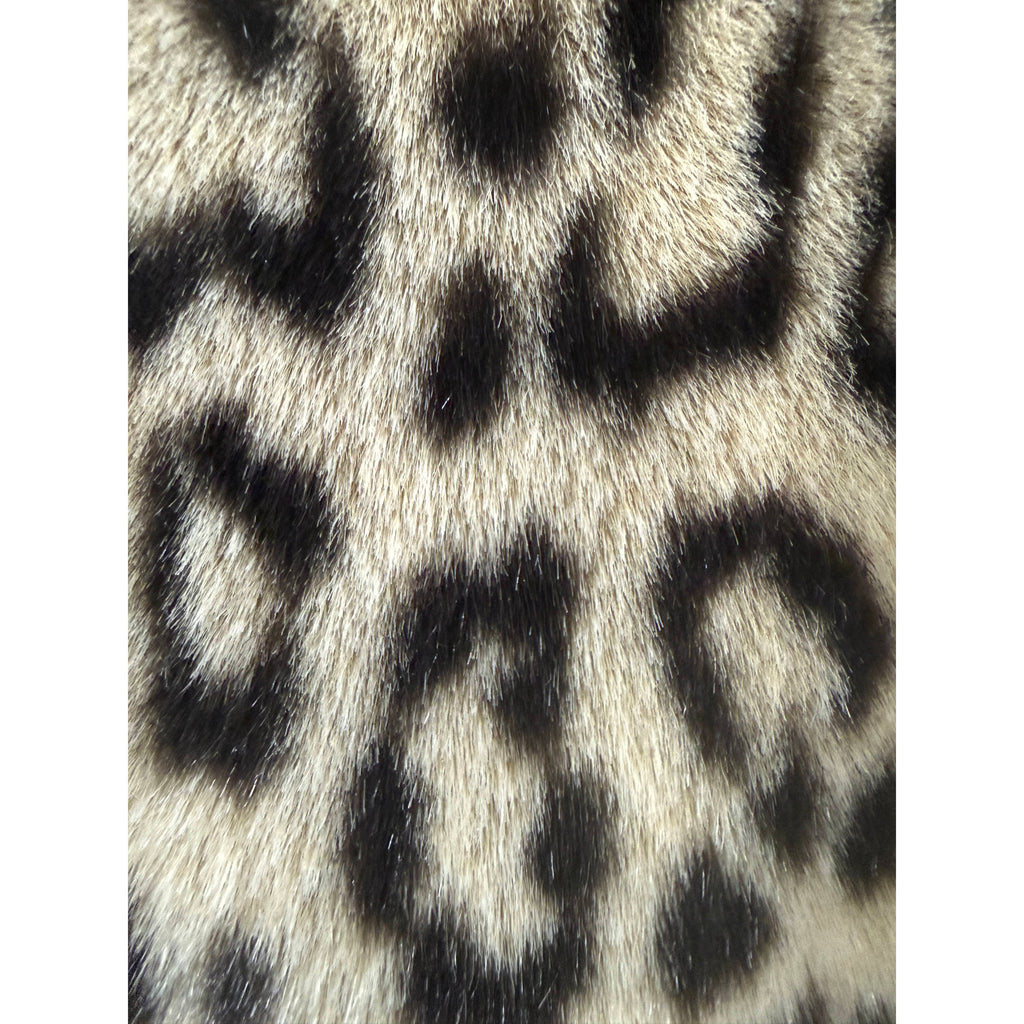 Close-up of dense French acrylic pile faux fur with realistic leopard markings and silky texture