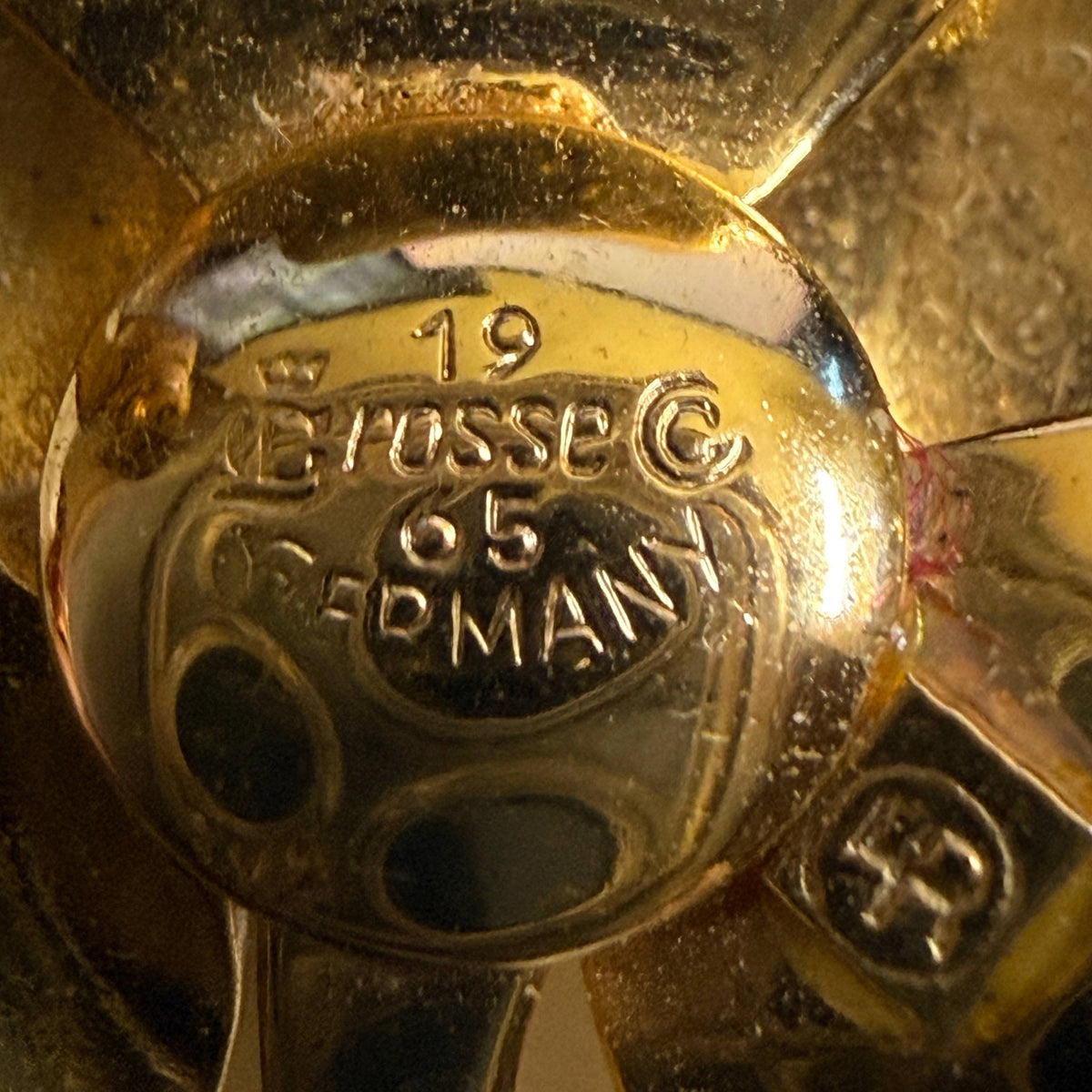 Close-up of GROSSE copyright 1965 GERMANY hallmark and Henkel and Grossé emblem on vintage brooch