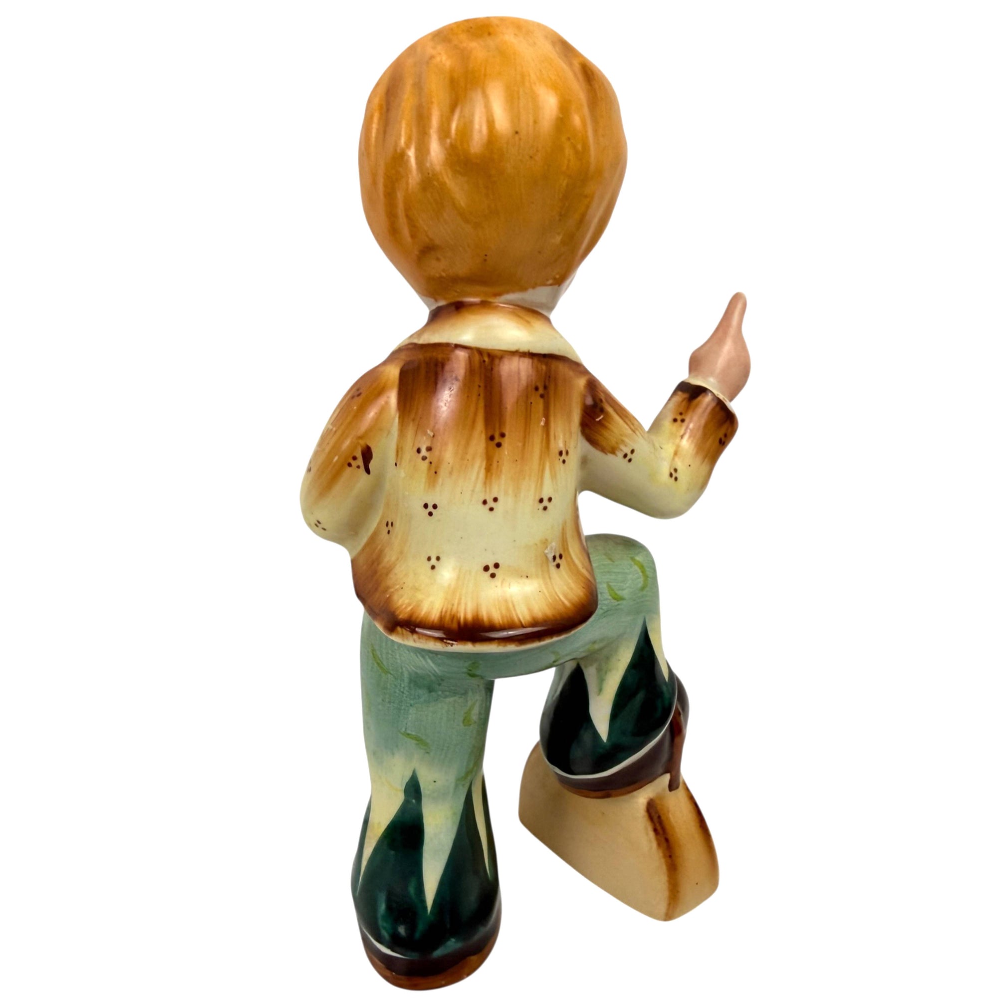 Hand painted ceramic pipe boy figurine standing on suitcase