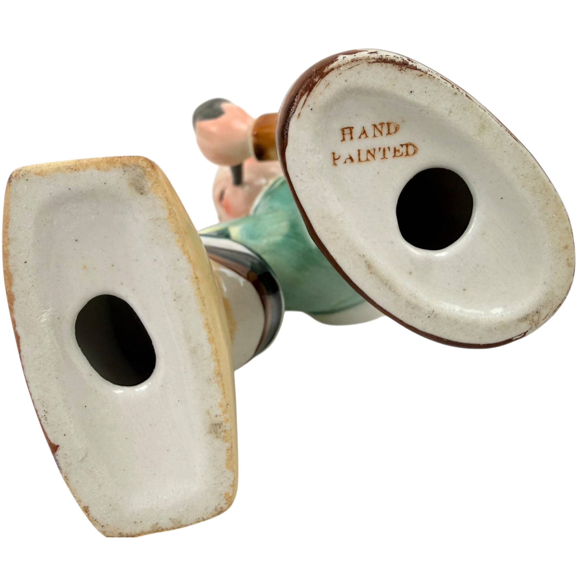 Underside of figurine base stamped Hand Painted