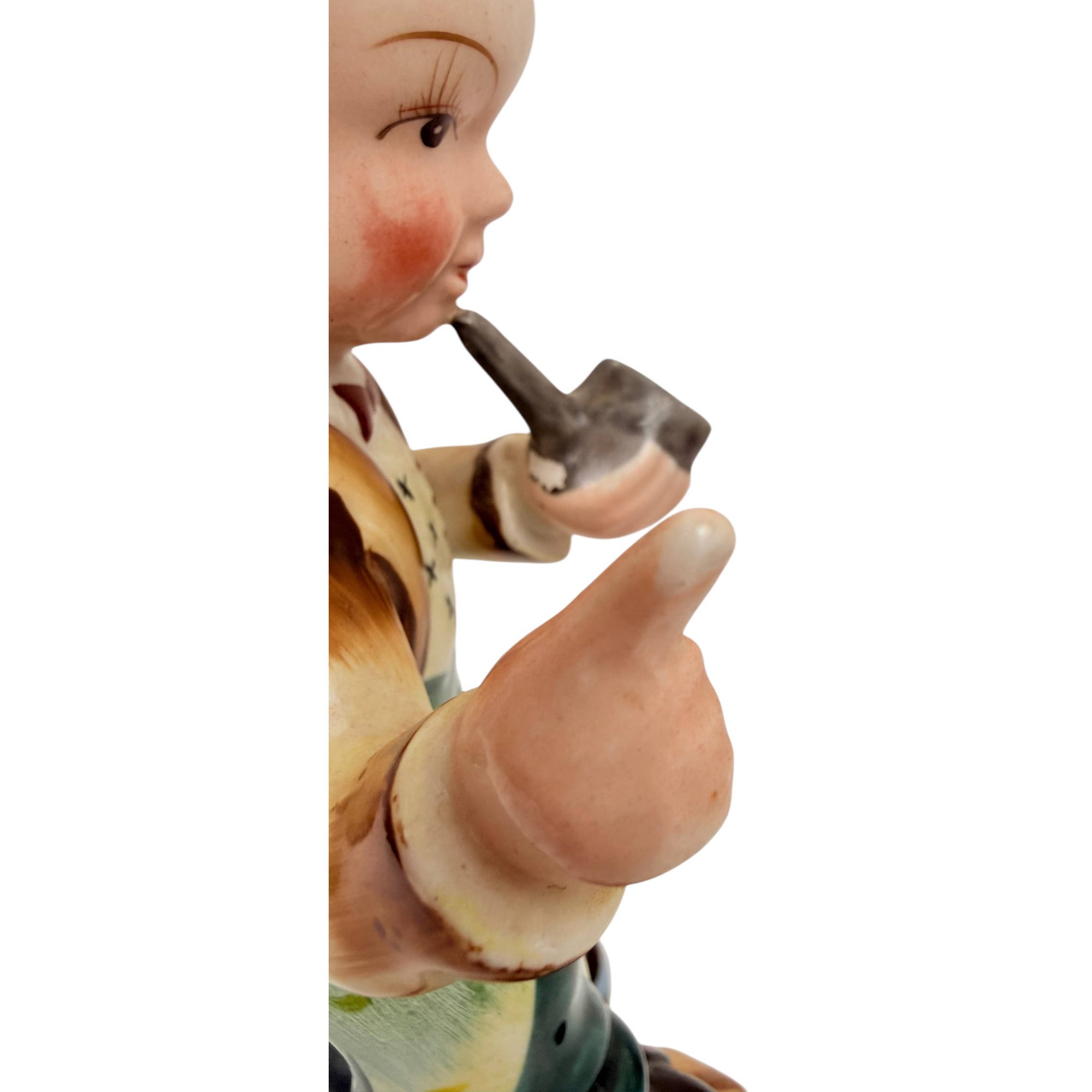 Detail of paint wear to thumb on comic pipe boy figurine
