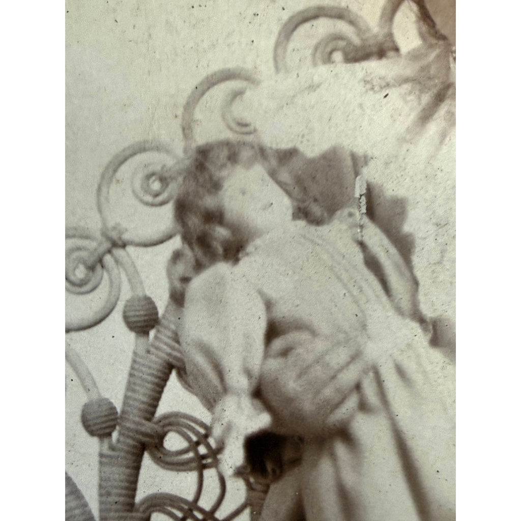 close-up of doll being held by a girl in a cabinet card photograph