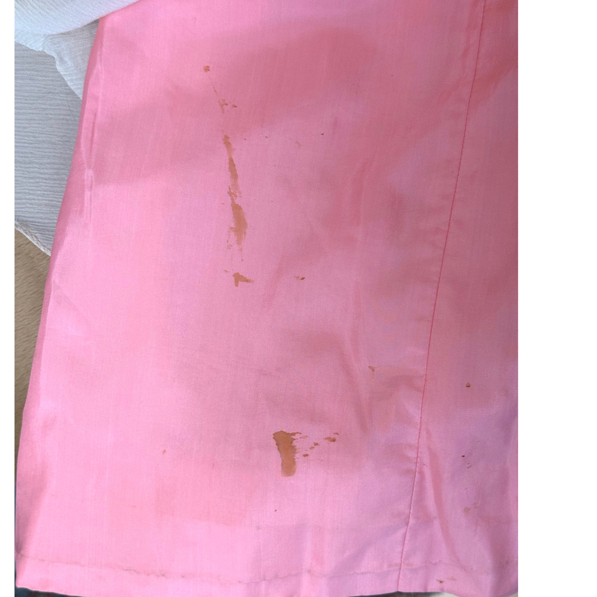 Close-up of stains to silk underlayer beneath chiffon overlay