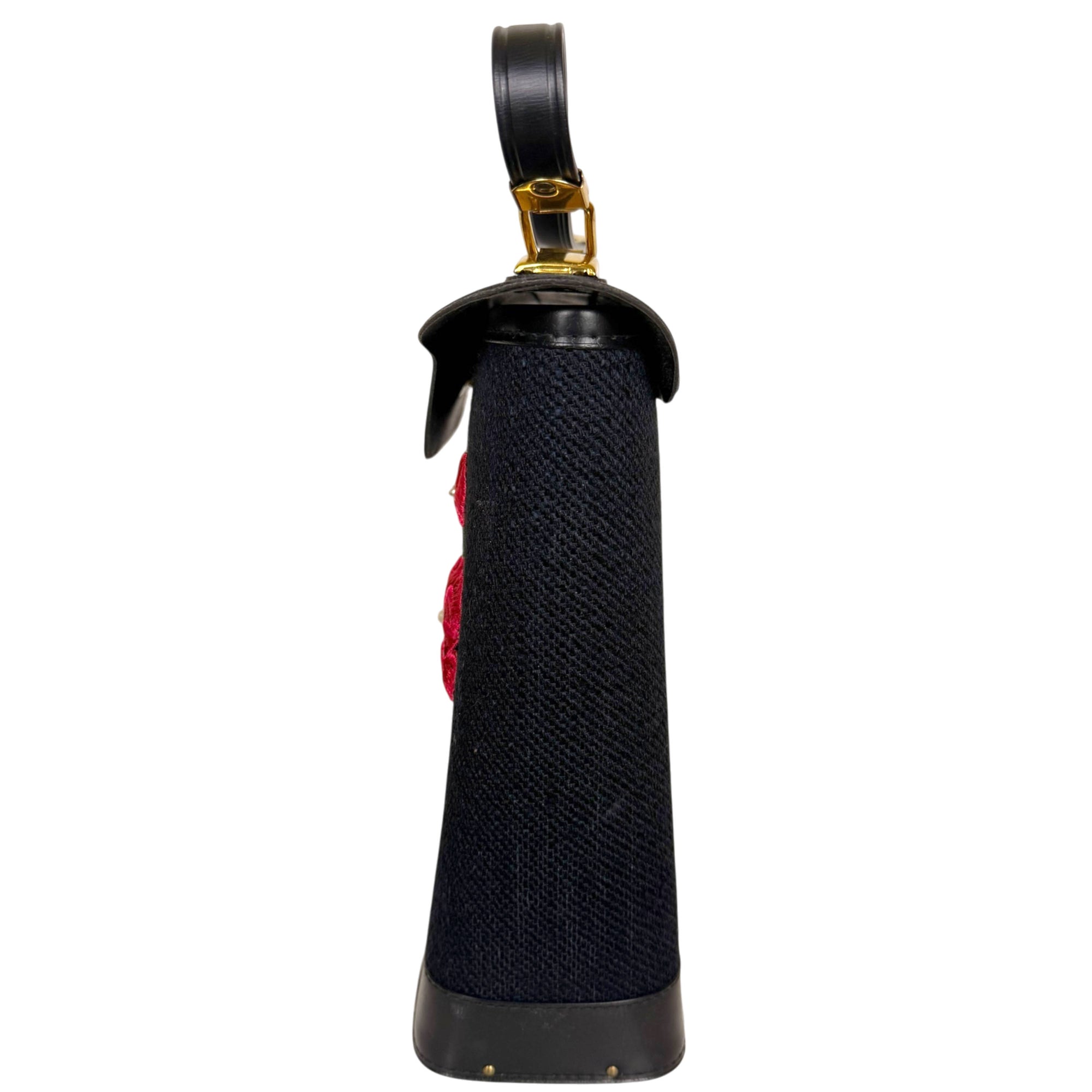 Side view of vintage black canvas and vinyl handbag