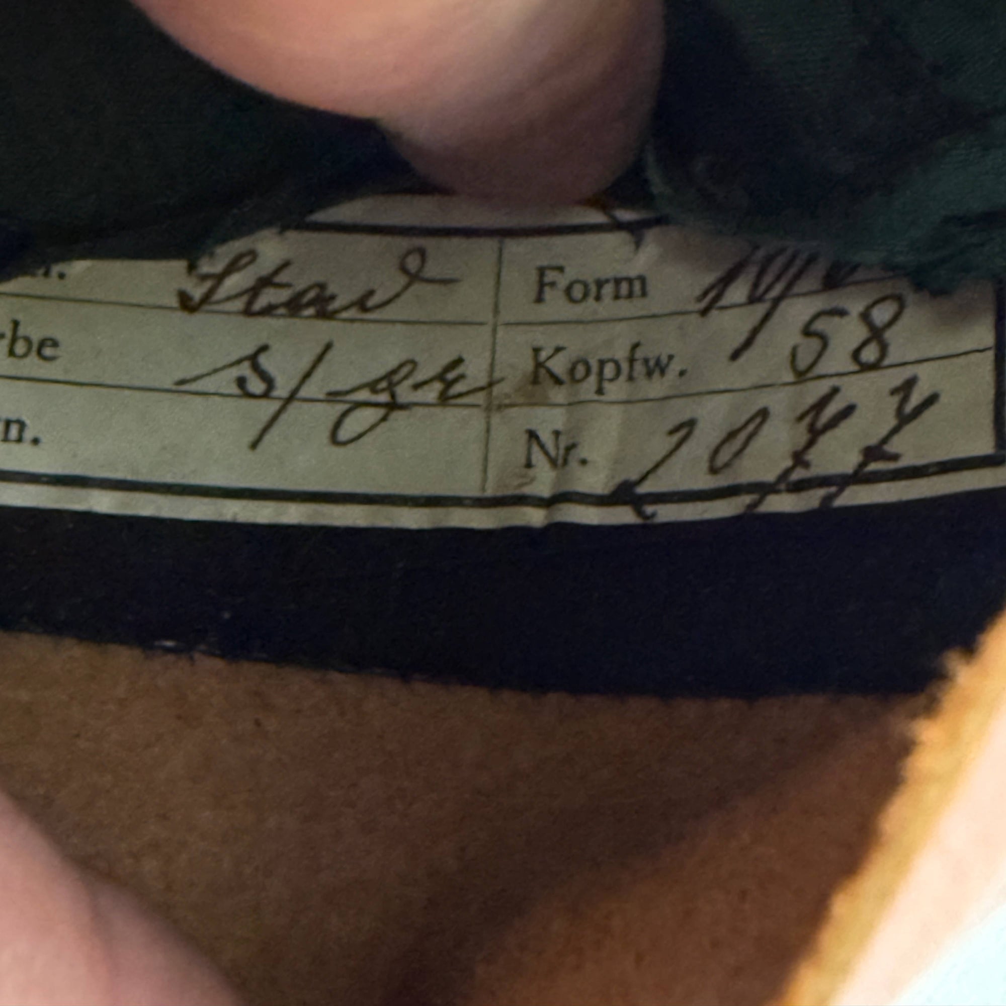 Original handwritten production tag inside hat