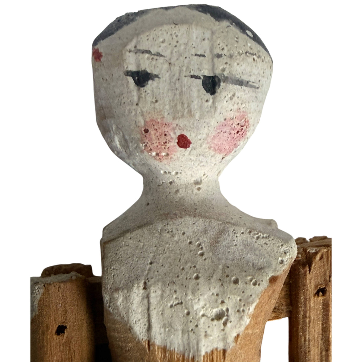 Close-up of antique Grödnertal Dutch penny doll showing black painted hair, rosy cheeks, red mouth and aged white painted surface