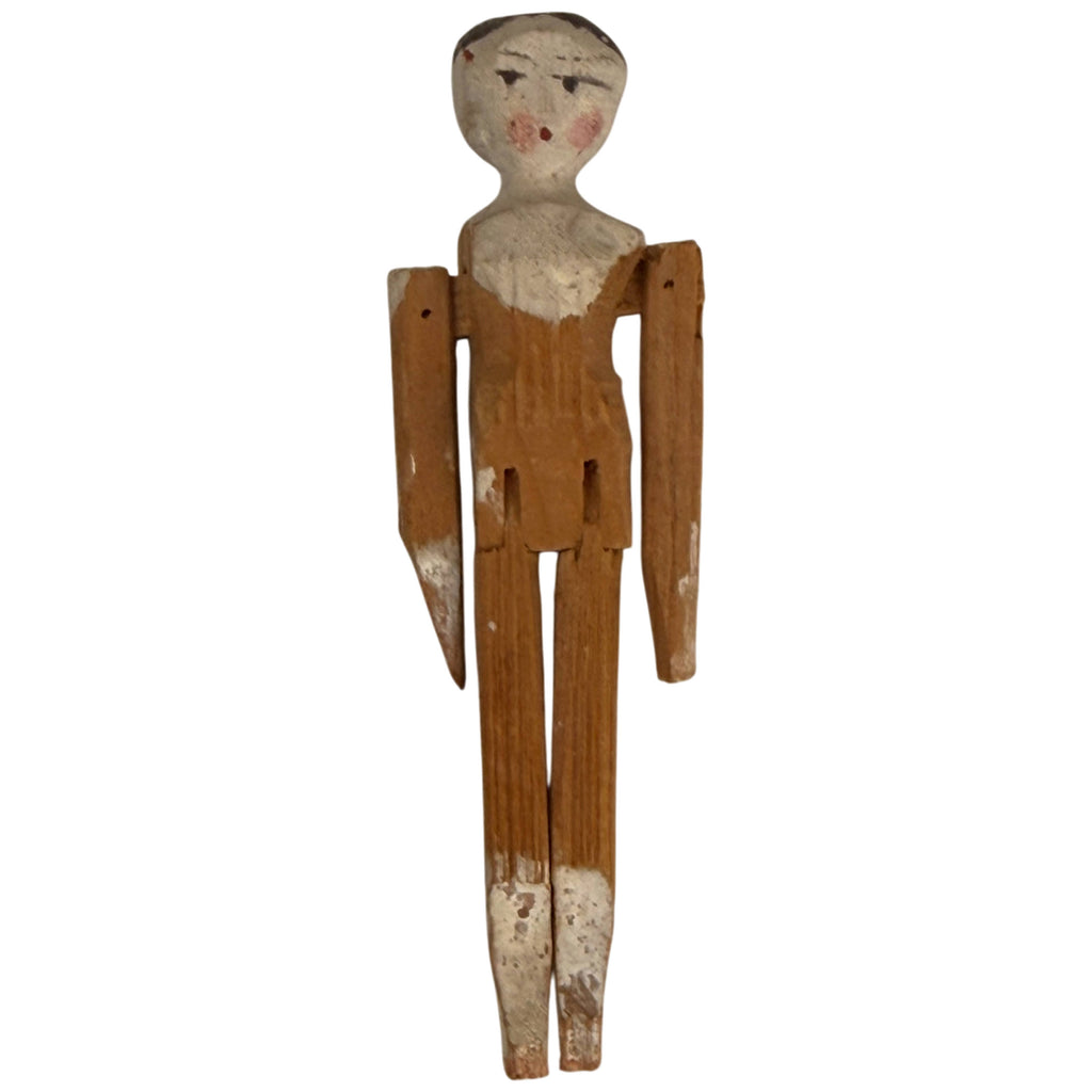 Antique German Grödnertal miniature wooden penny doll with hand-painted face, jointed arms and legs, measuring 3 3/8 inches tall.