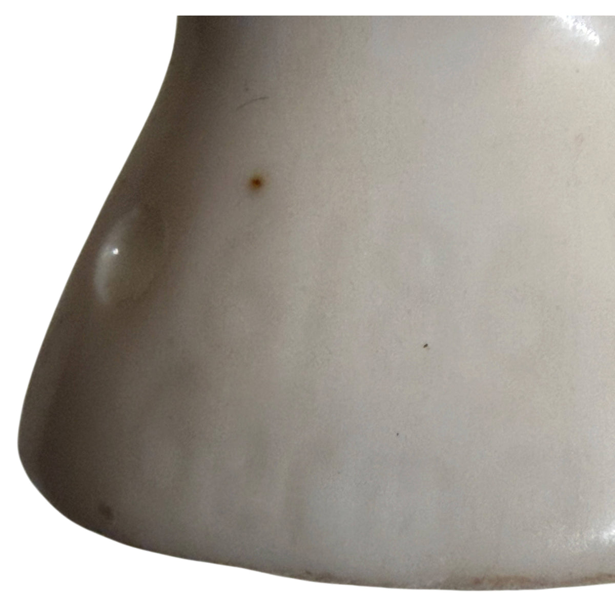 Close-up of glazed white porcelain on lower back of antique German half-doll showing impressed markings 
